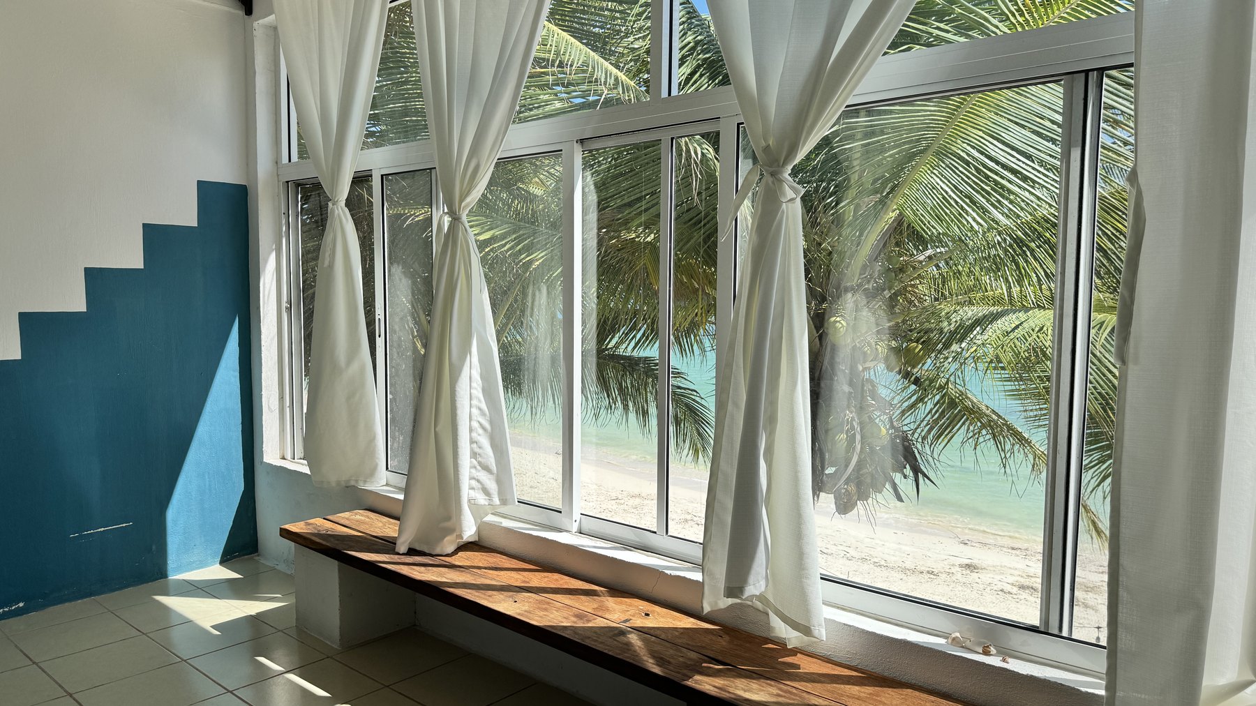 Room facing the sea at Casa Pronoia, with the window bench and the Caribbean outside