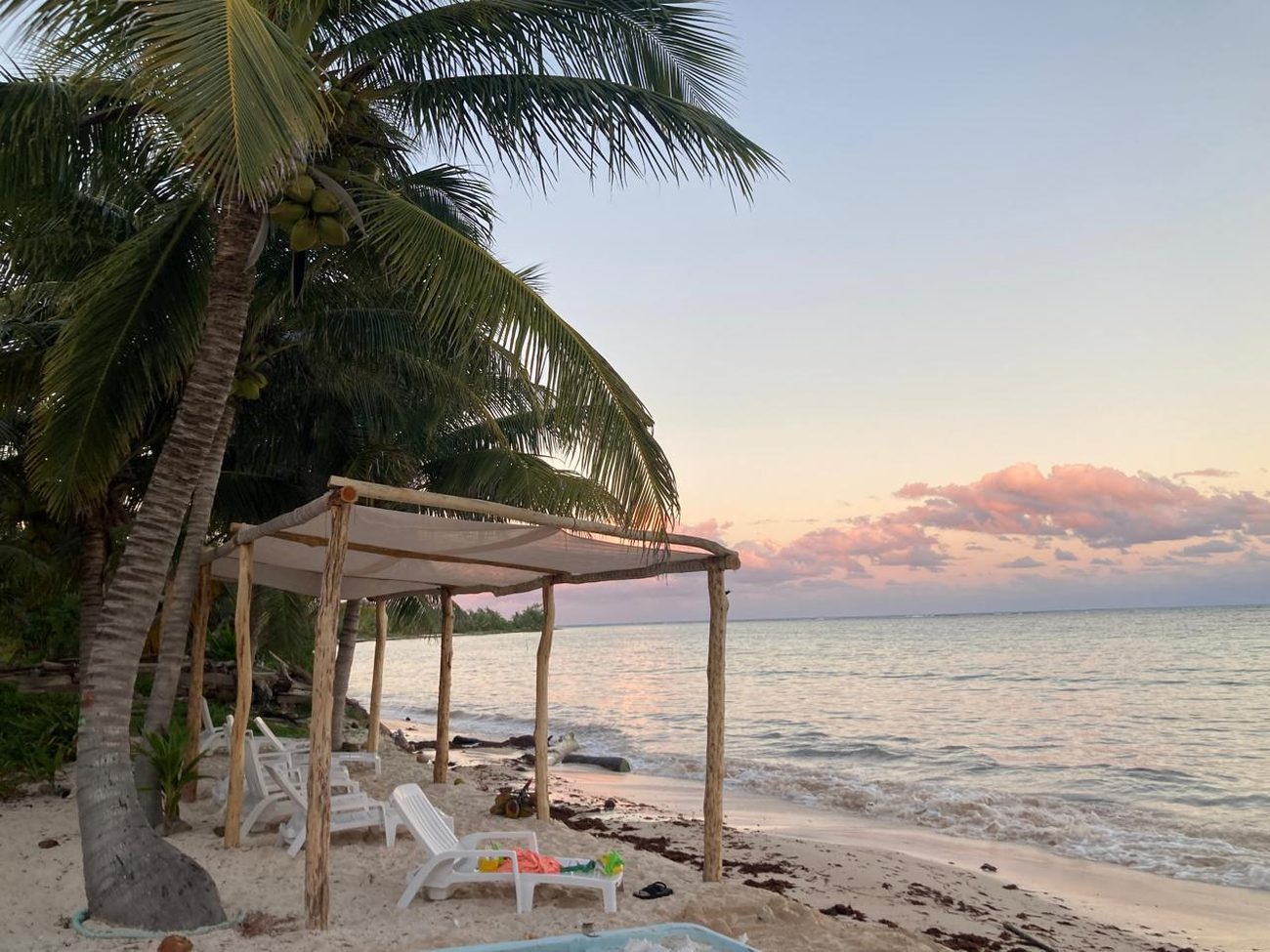 Shaded loungers on the beach at Pronoia, Costa Maya day pass